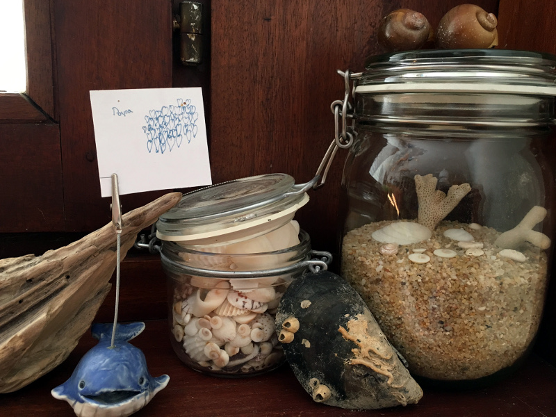 Jahreszeiten-Ecke mit Sommer-Glas voll mit Muscheln und Sand